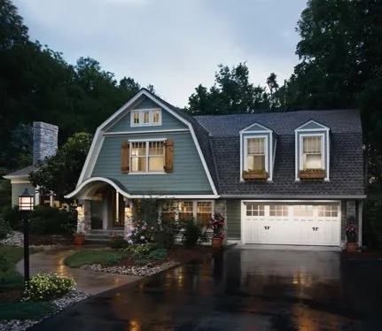 White barn-style home with carriage garage door 