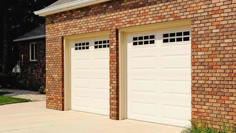 Almond color traditional garage doors with long panels 