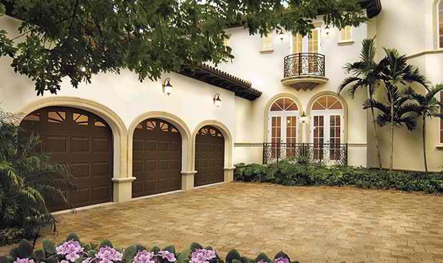 Chocolate colored traditional garage door with round top 