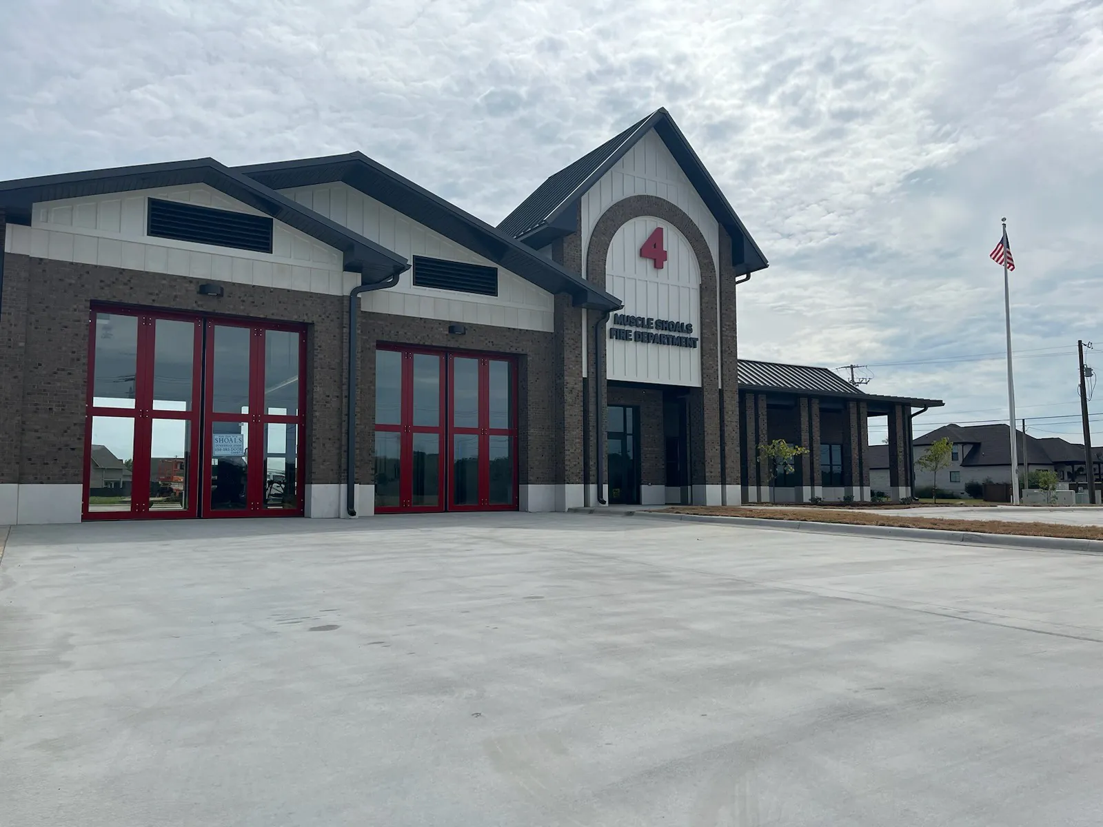 Fire department facility with commercial door openings