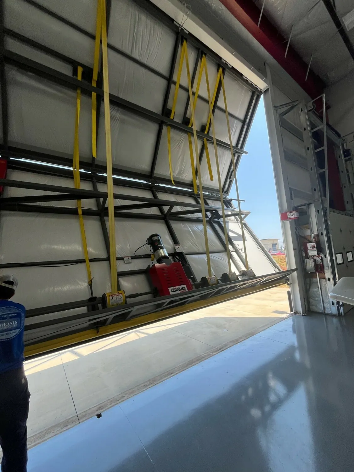 Technician servicing a commercial door system