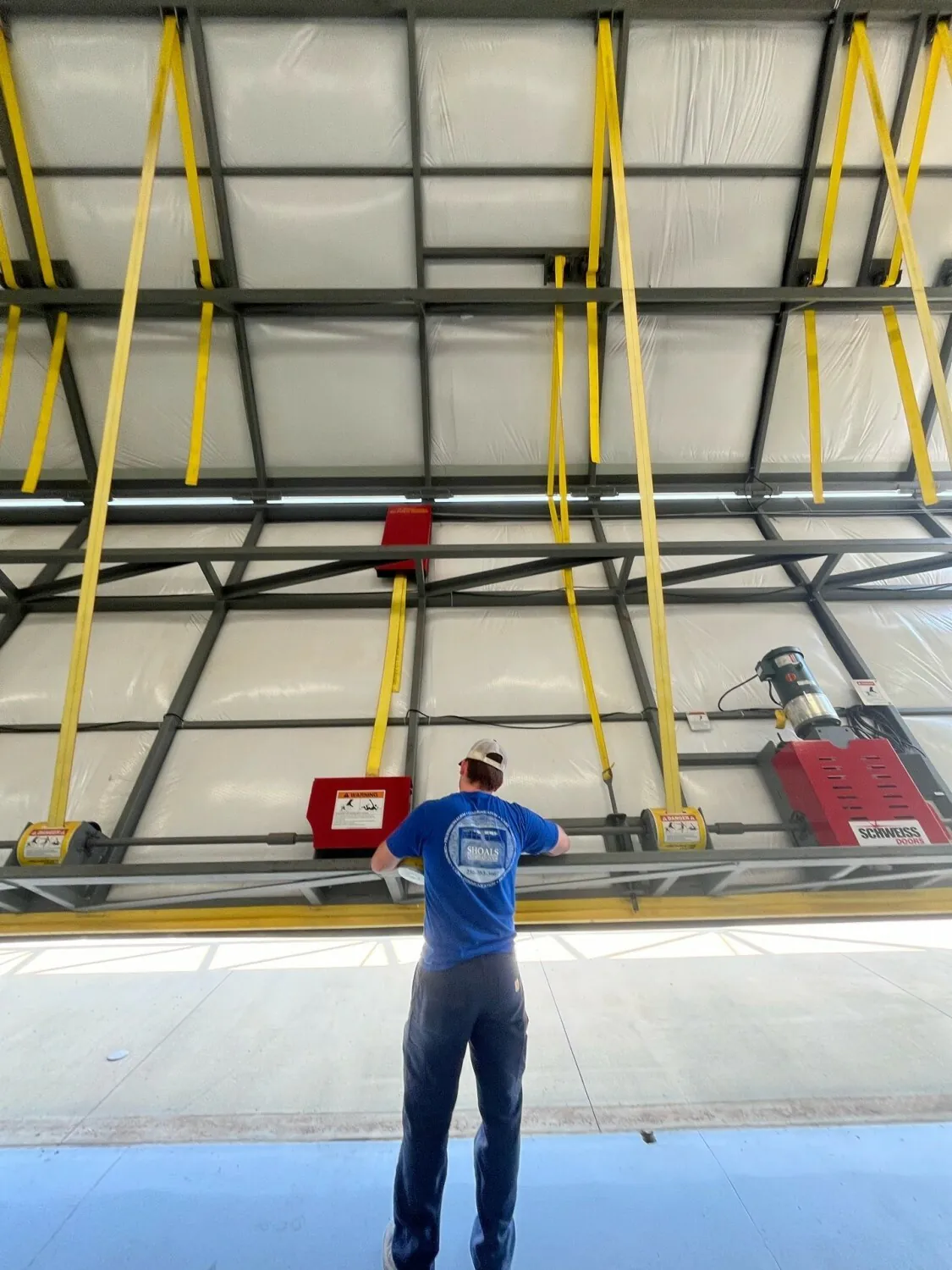 Technician adjusting a commercial door operator